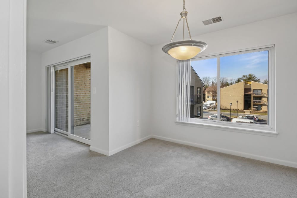 Dining area with access to balcony at Annen Woods Apartments in Pikesville, Maryland