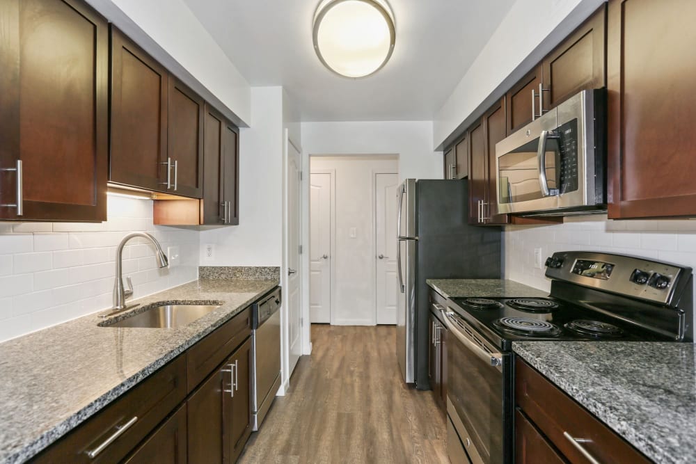 Model kitchen with stainless-steel appliances at Annen Woods Apartments in Pikesville, Maryland