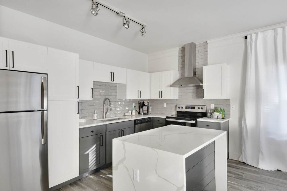 Fully-equipped kitchen with stainless-steel appliances with island countertop at Sullivan in Austin, Texas
