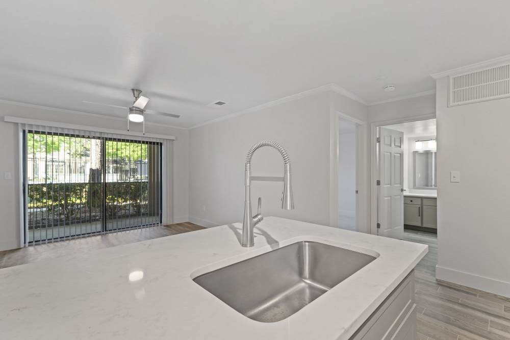 Gooseneck faucet and the granite countertops in the kitchen at Seacrest in Katy, Texas
