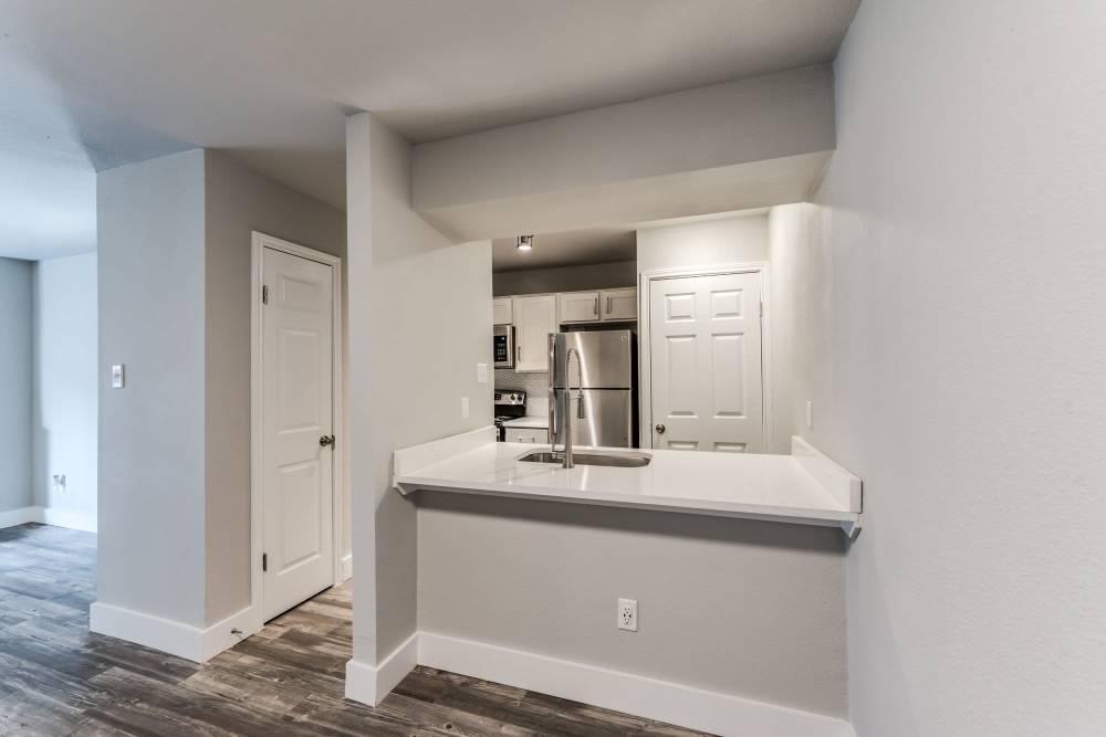 Kitchen view from the living room at Warwick at Westchase in Houston, Texas