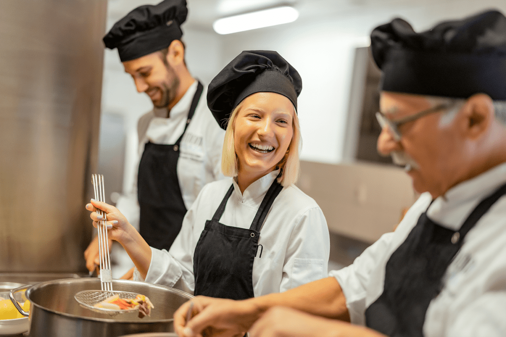 Chefs cooking together at Pillars Senior Living in Lakeville, Minnesota