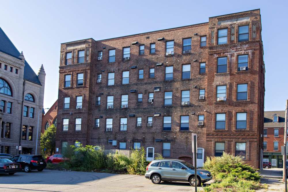 Brick building with multiple windows at The Majestic in Lowell, Massachusetts