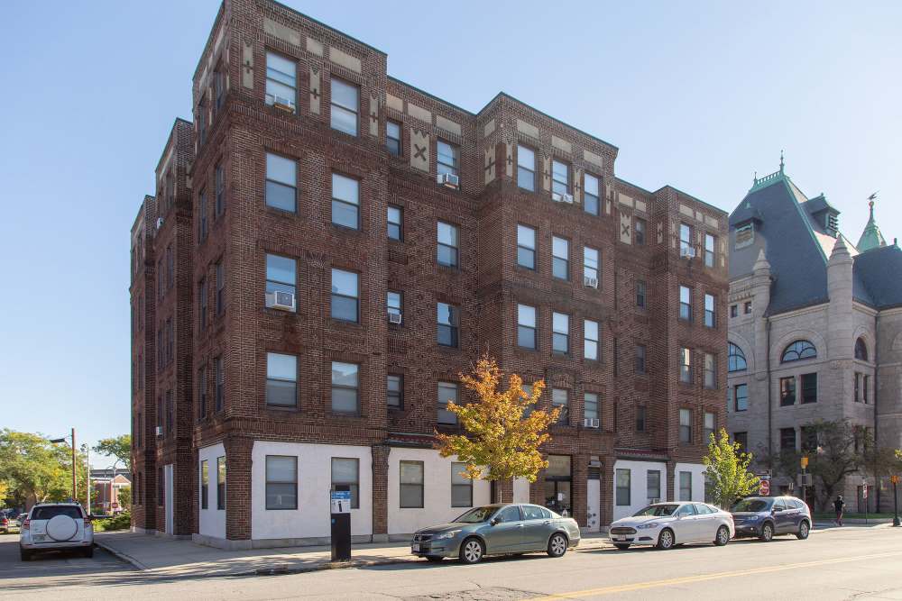 Brick apartment building with multiple windows at The Majestic in Lowell, Massachusetts
