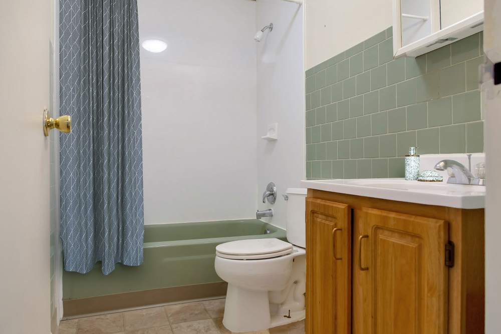 Wooden cabinet with sink and mirror at The Majestic in Lowell, Massachusetts
