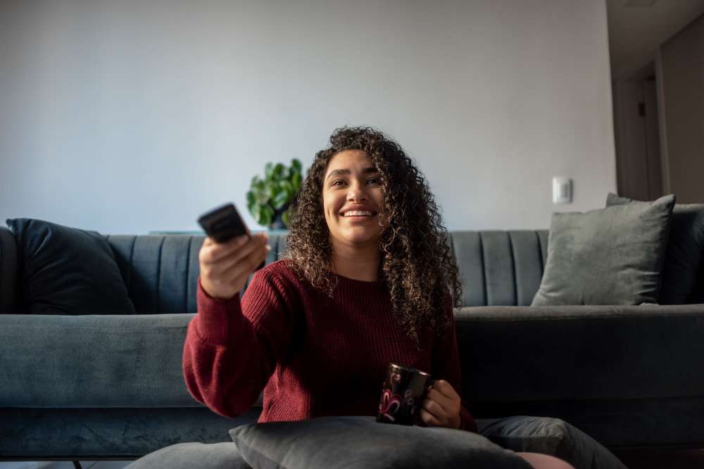Resident watching TV in her home at Canyon Townhomes in Phoenix, Arizona
