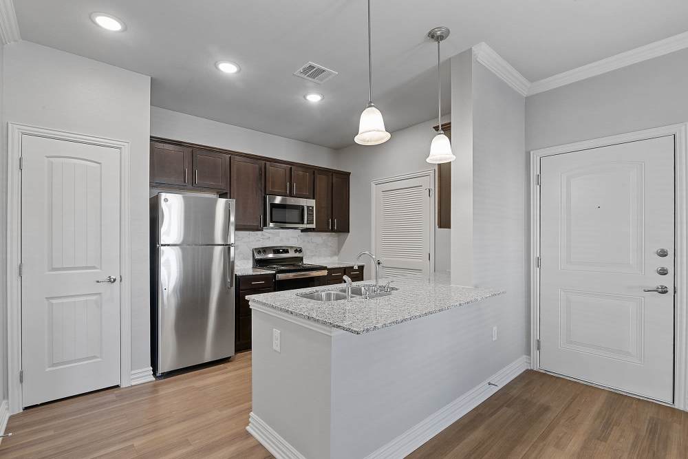 Kitchen with breakfast counter at Stonebridge Apartment Homes in Lufkin,Texas