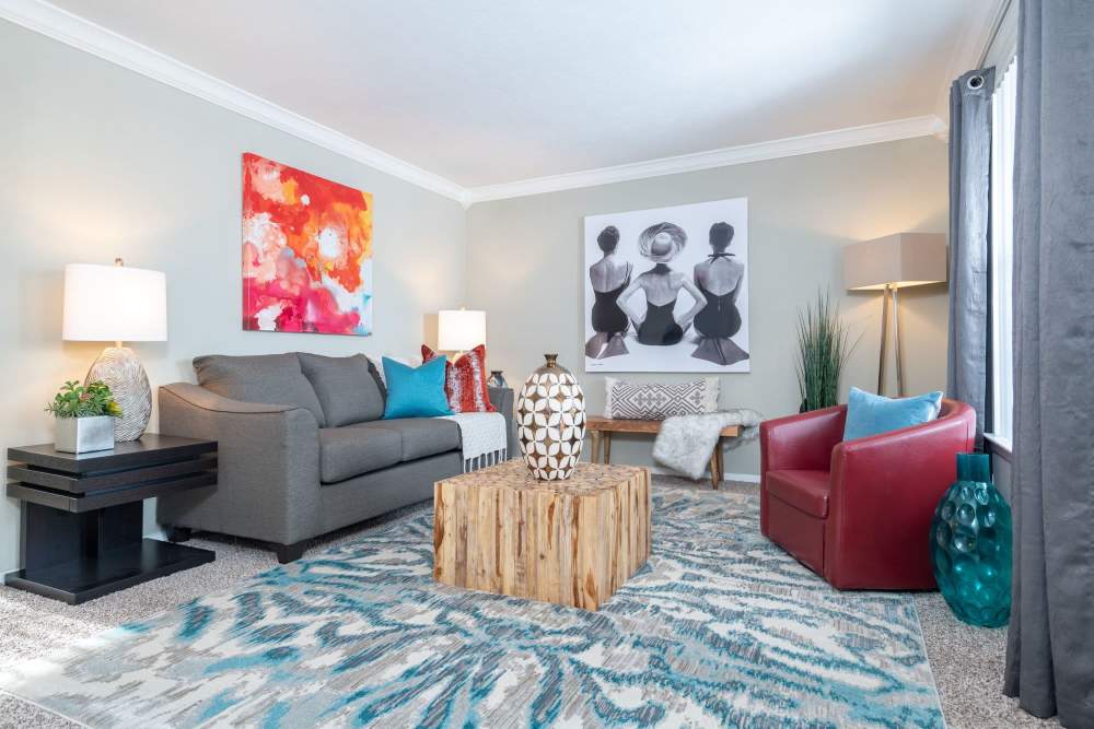 Living room with large sofa and side lamp at Del Prado at Texas Star in Euless, Texas