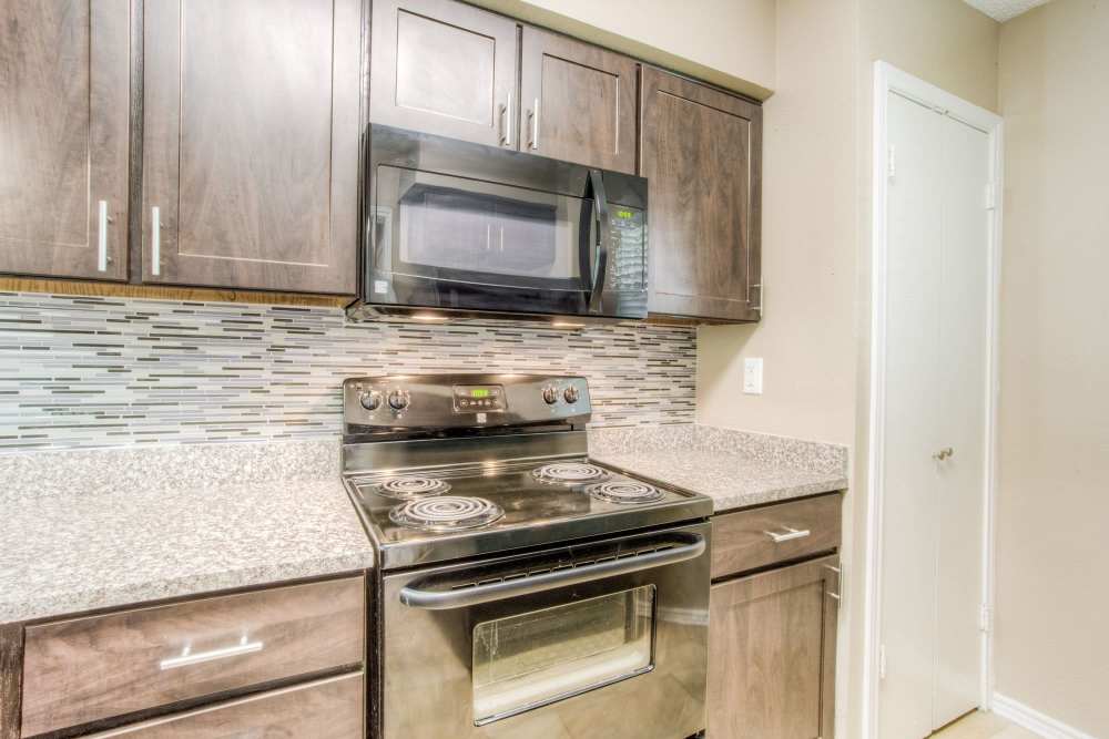 Kitchen with steel appliances at The Quorum At Trophy Club in Trophy Club, Texas