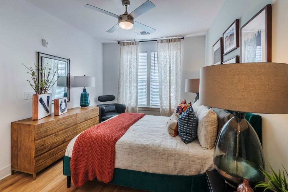 Model bedroom with ceiling fan and large window at The Collins in Charlotte, North Carolina