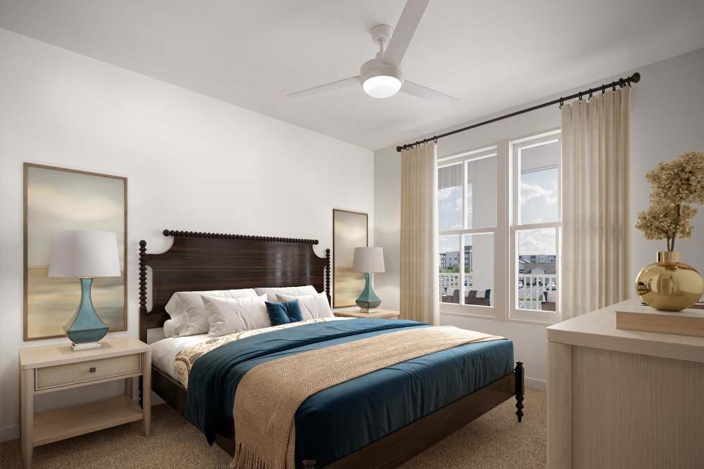 Cozy bedroom with large windows at Romero Apartments in Pensacola, Florida