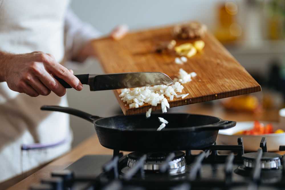 Chopping onions in modern kitchen with granite countertops at The Residences at Talcott in Weatogue, Connecticut