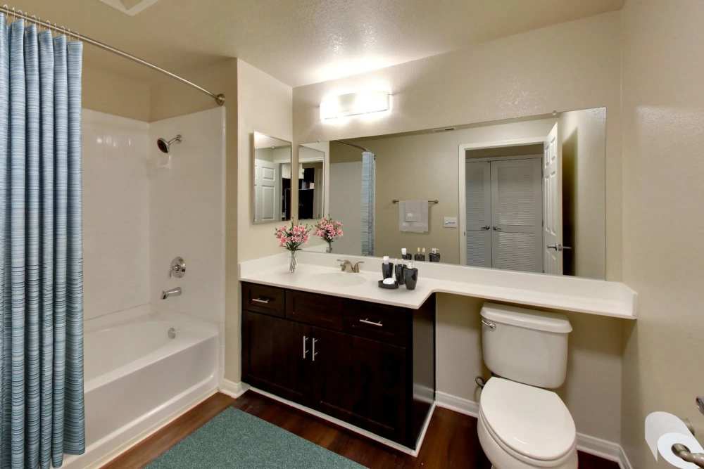 A bathtub with separate water closet and vanity at Hawthorn Village Apartments in Napa, California