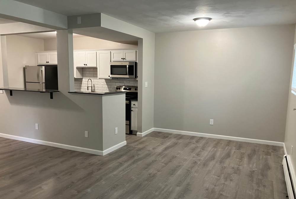 Open kitchen with wood flooring at Country Manor Apartment Homes in Webster. NY