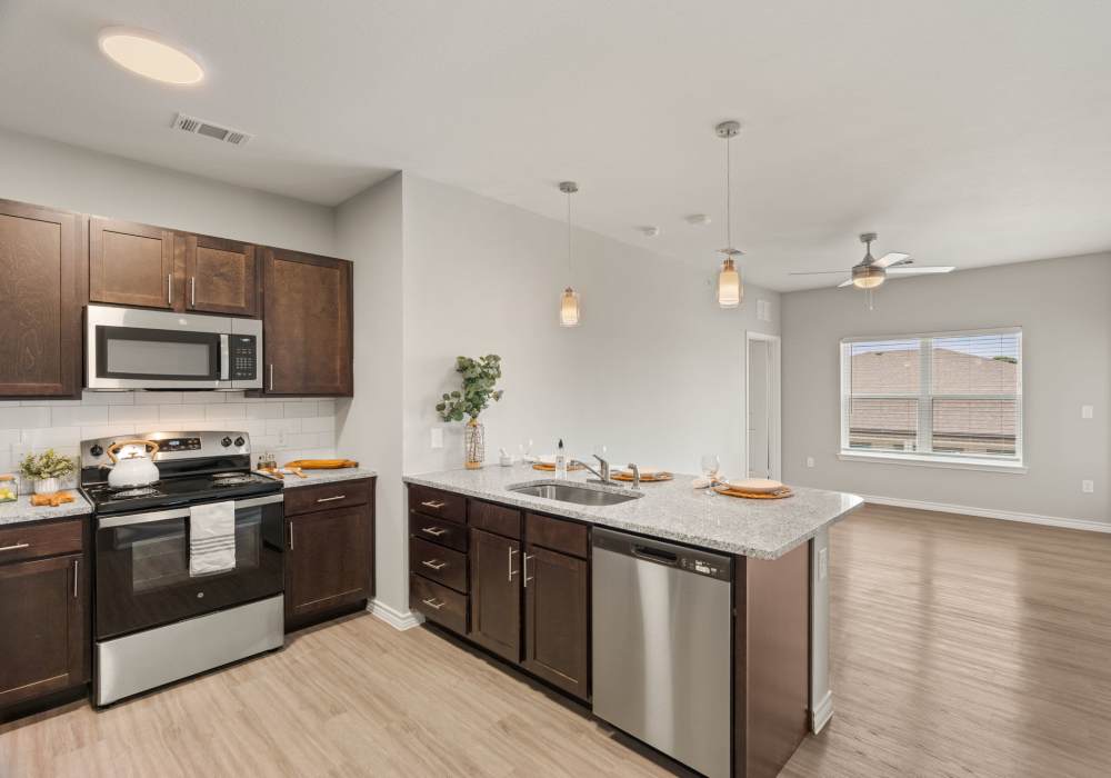 Kitchen with island and appliances at Walnut Springs in Seguin, Texas