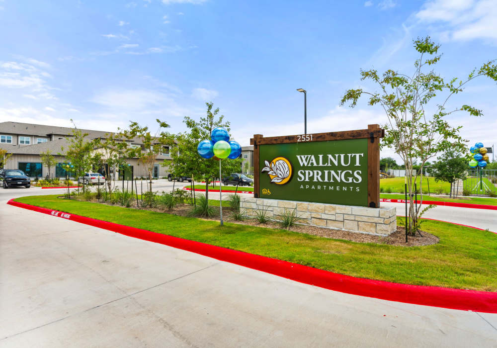 Apartment community entrance signage at Walnut Springs in Seguin, Texas