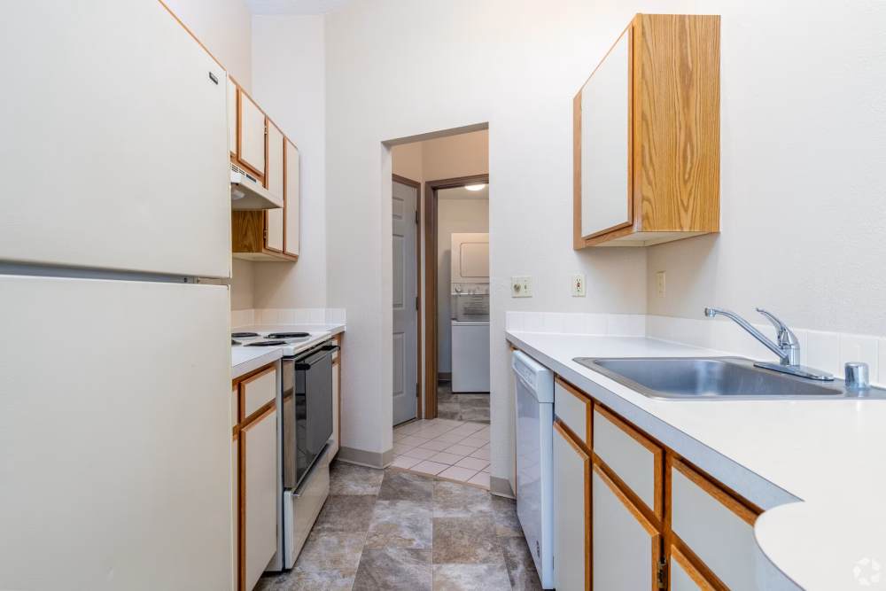 Modern kitchen with sink and access to washer & dryer at Stonecrest Apartments in Spokane, Washington