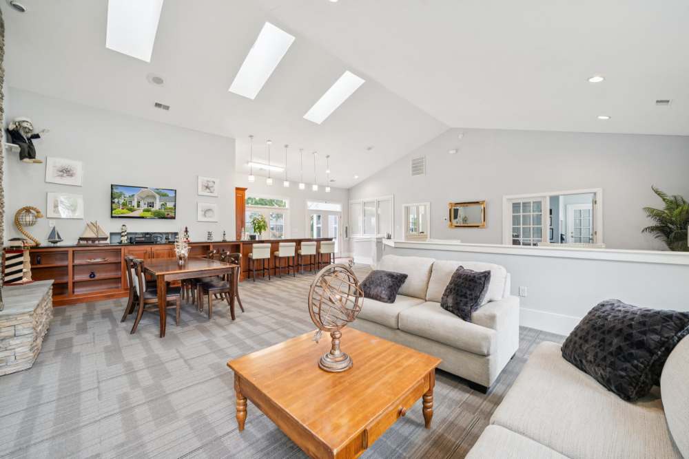 Clubhouse with large sofa and view to dining area at Pilot House in Newport News, Virginia