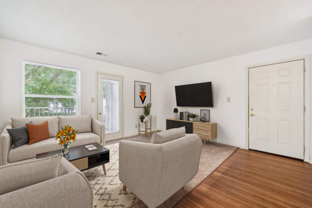 Living room with television and access to patio at Pilot House in Newport News, Virginia