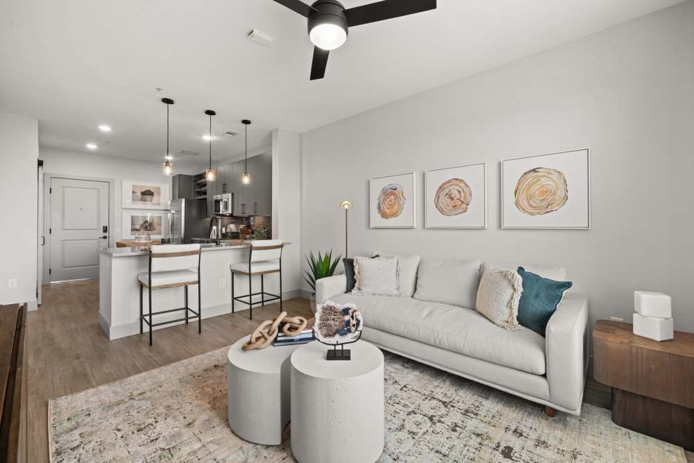 Well-furnished living area in an open-concept model home at The Lock at Flatirons in Broomfield, Colorado