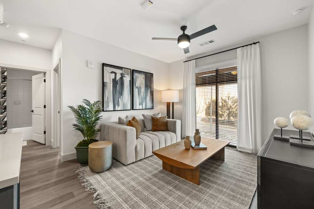 Modern furnishings in the open-concept living area of a model apartment at The Lock at Flatirons in Broomfield, Colorado