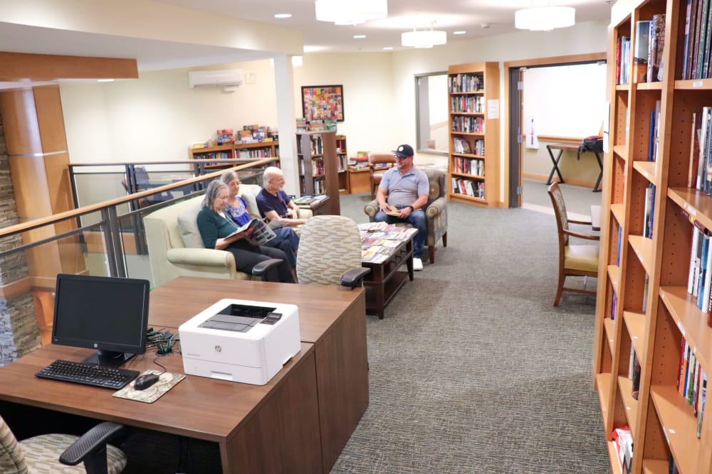 Residents sitting in library area at The Springs at Greer Gardens in Eugene, Oregon