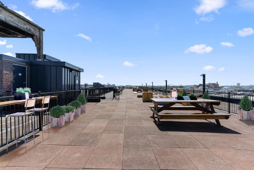 Rooftop seating area with picnic tables at Brush Factory Lofts in Philadelphia, Pennsylvania