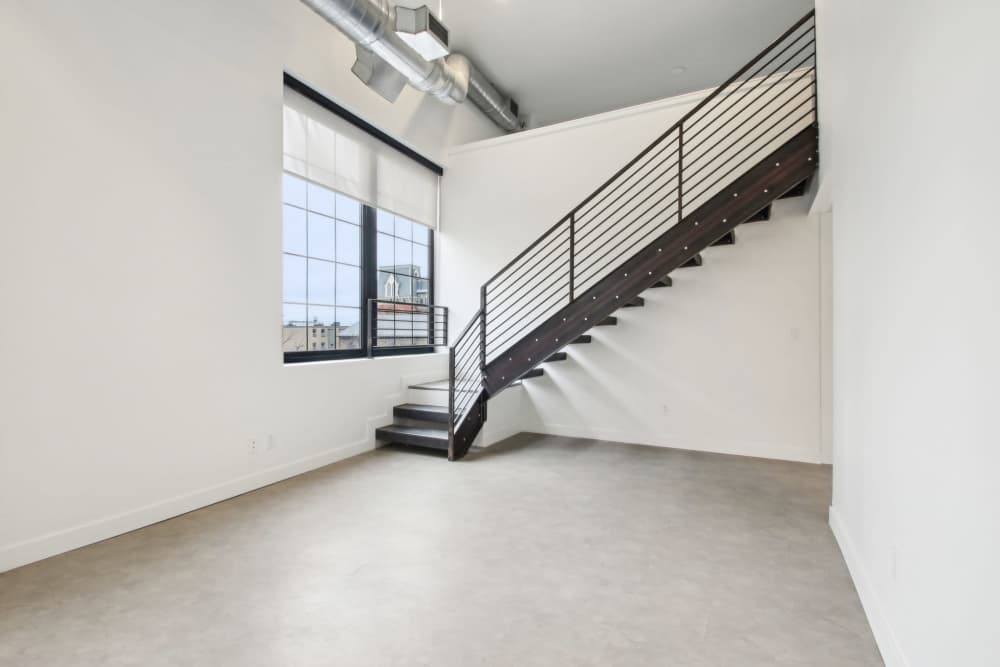 Comfortable living space and a staircase at The Edmond in Rochester, New York
