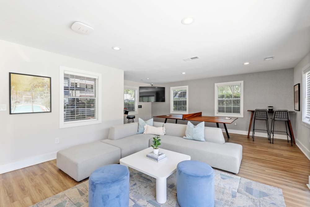Community clubhouse with large couch, chairs and wood-style flooring at Preserve at Dunwoody in Dunwoody, Georgia