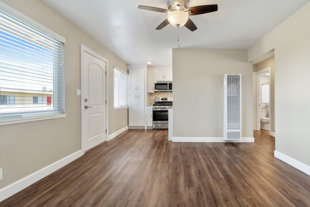 Unfurnished living room with hardwood-style flooring and front door at Bon Aire Apartments in Castro Valley, California