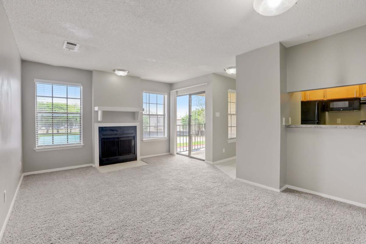 Unfurnished living with carpet flooring and fireplace at Copper Mountain in Killeen, Texas