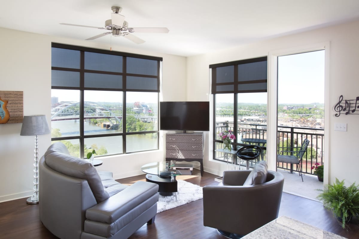 Modern living room with window at City View Apartments in Nashville, Tennessee