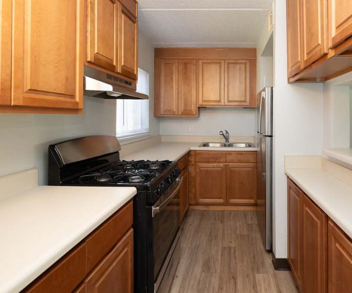 Kitchen with stove at Monaco Arms in Jacksonville, Florida