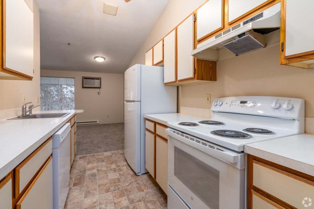 Modern kitchen with white appliances at Stonecrest Apartments in Spokane, Washington