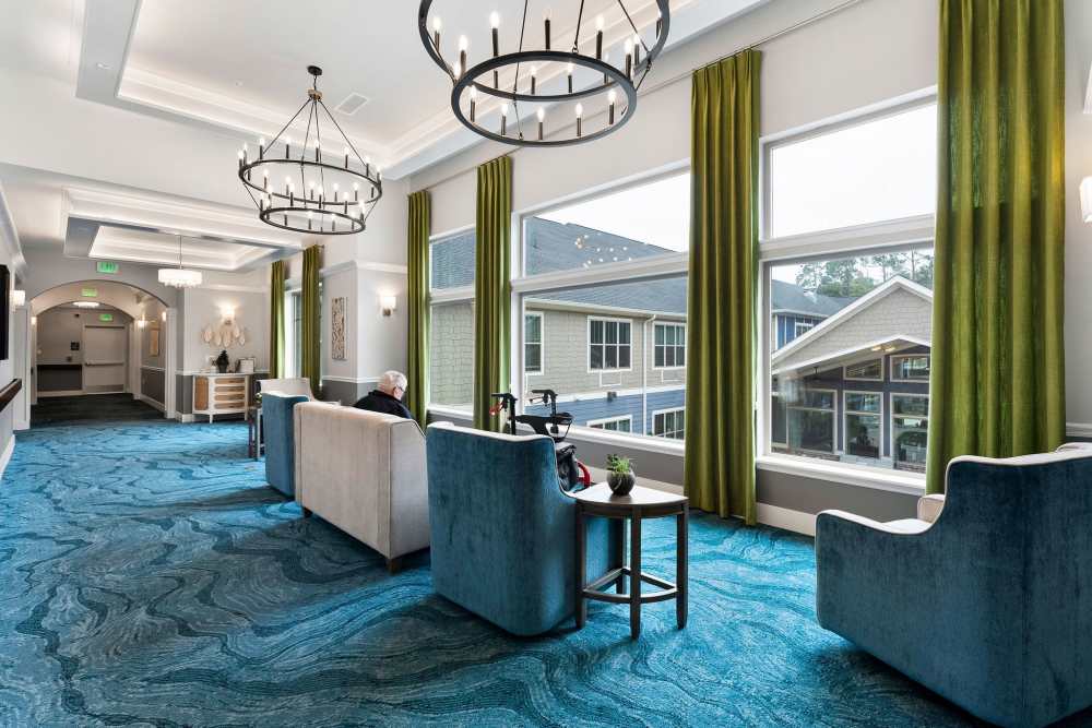 Clubhouse with couch, chairs and large window at The Barclay at Whiskey Road in Aiken, South Carolina