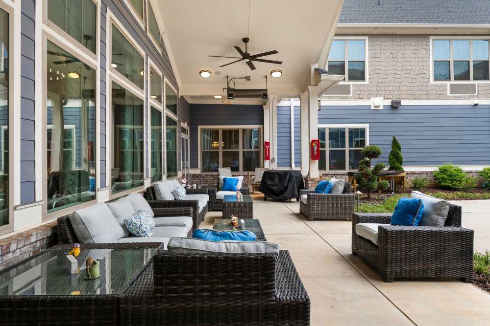 Common outdoor seating area with couch and chairs at The Barclay at Whiskey Road in Aiken, South Carolina