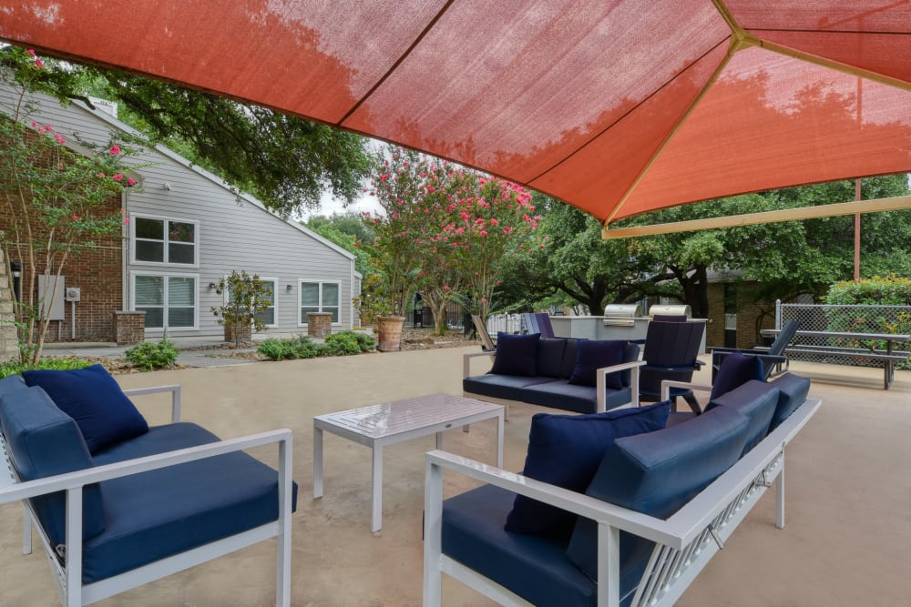 Covered couches and seating in a community outdoor space at Villas de Santa Fe in San Antonio, Texas