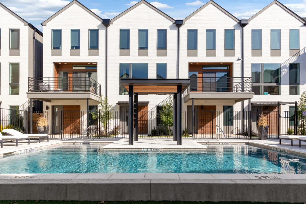 Exterior of town homes and inground pool at The Collection Townhomes in Dallas, Texas