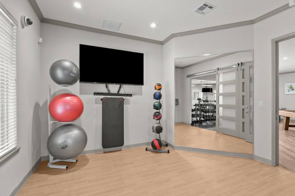 Fitness center with television at The Loop in Conroe, Texas
