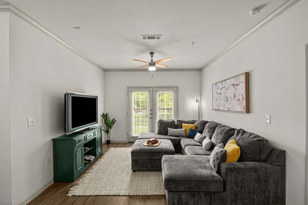 Living room with wooden flooring at The Loop in Conroe, Texas