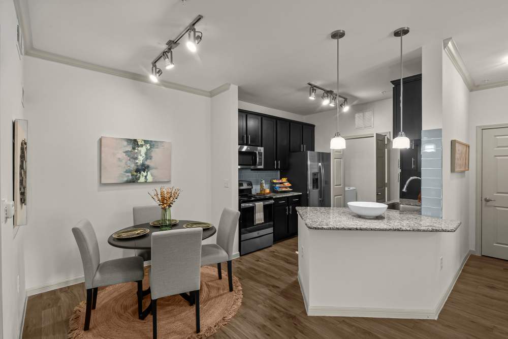 Kitchen with access to dining area at The Loop in Conroe, Texas