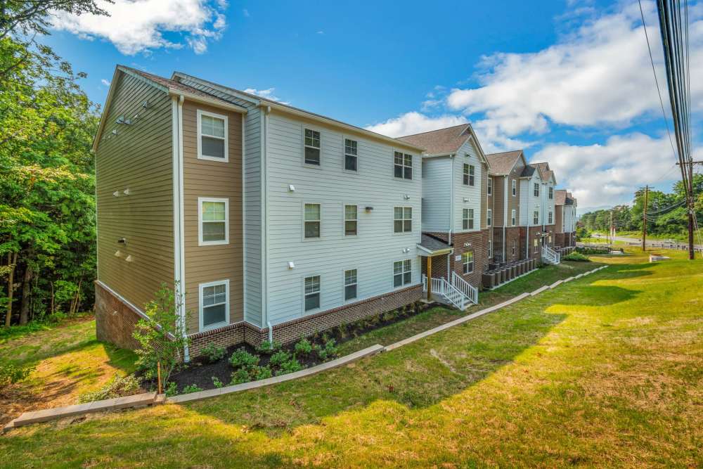 Exterior view of apartments surrounded by greenery at Magnolia Greene in Lavale, Maryland