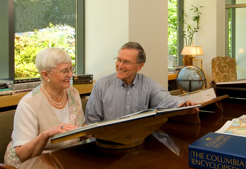 Residents in the library at Carefield Living.