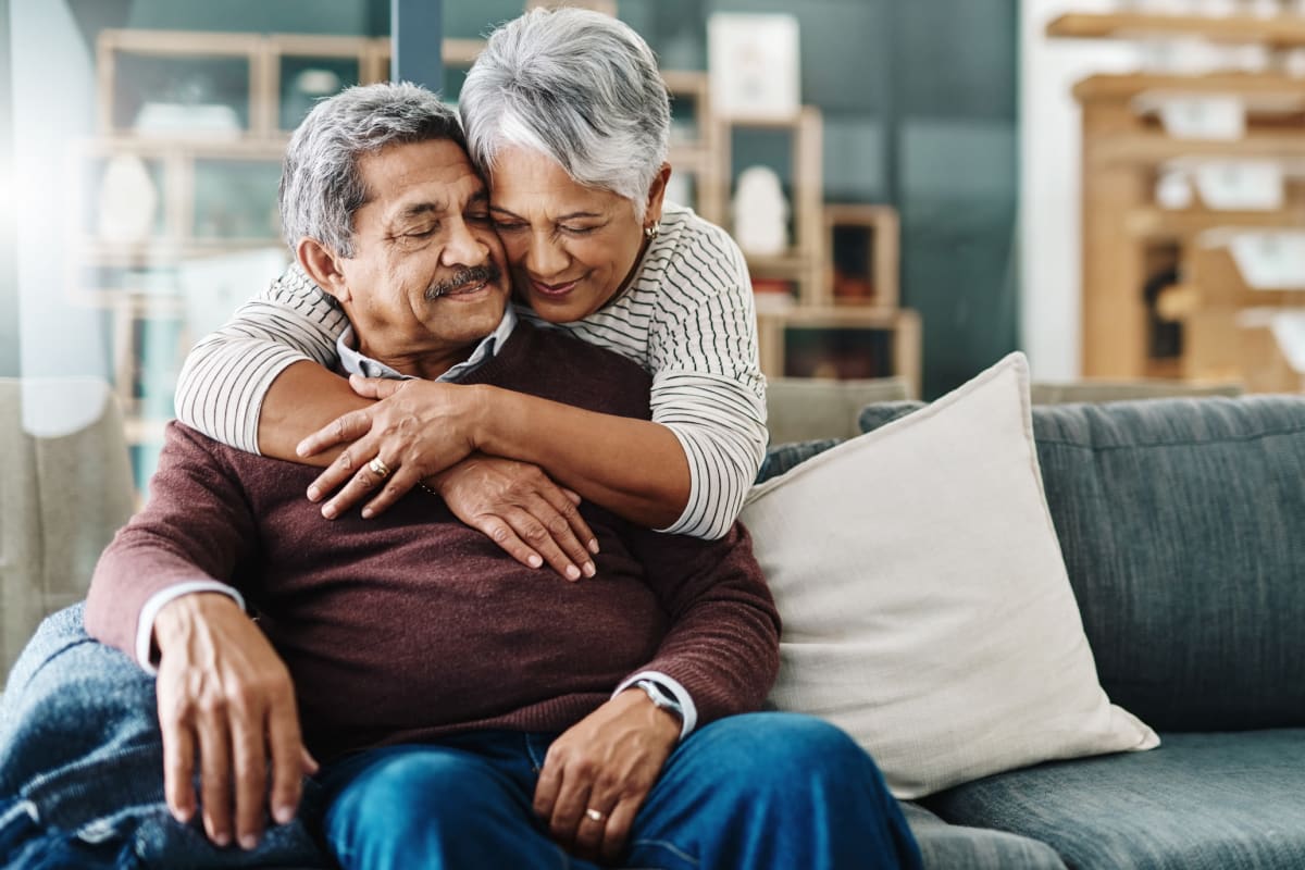 A resident couple hugging at Claiborne Senior Living.