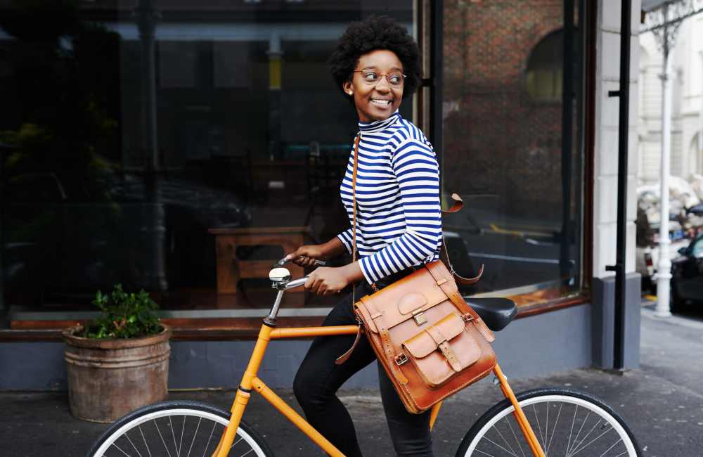 Resident smiling and walking her bike home to Mountain Brook Townhomes in Nashville, Tennessee