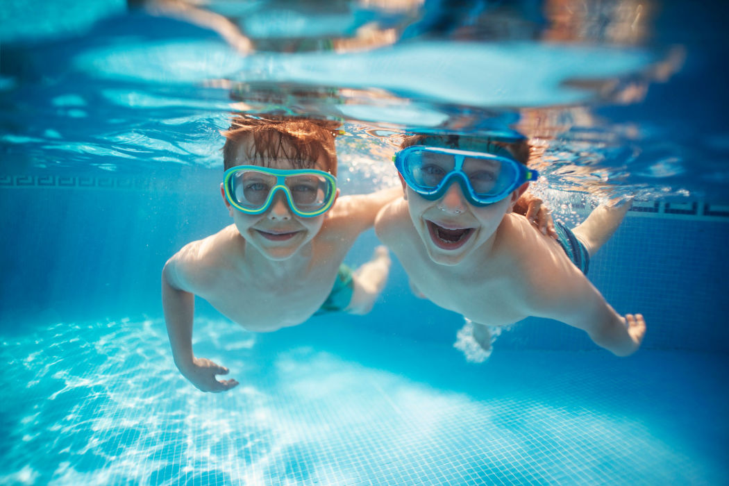 Kids swimming in the pool at IMT Kingwood in Kingwood, Texas
