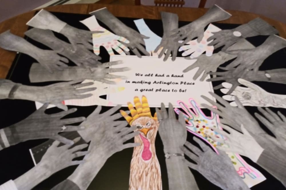 An all resident craft project showing hands and an inspirational quote at Arlington Place of Red Oak in Red Oak, Iowa
