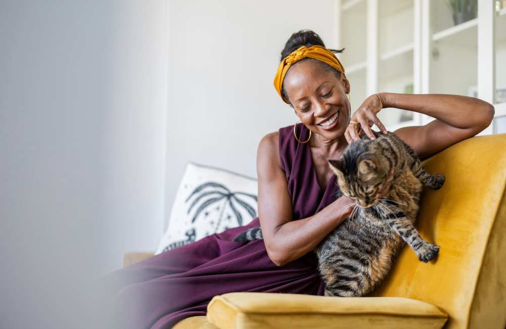 Resident petting her cat on the patio at Mountain Brook Townhomes in Nashville, Tennessee