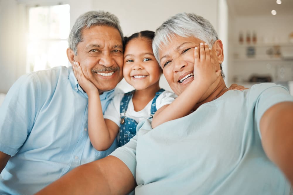 Resident couple being visited by a younger family member at Regency on Whidbey in Oak Harbor, Washington