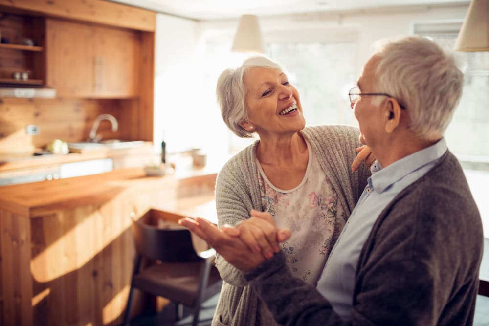Two residents dancing in their apartment at Quail Park of Lynnwood in Lynnwood, Washington